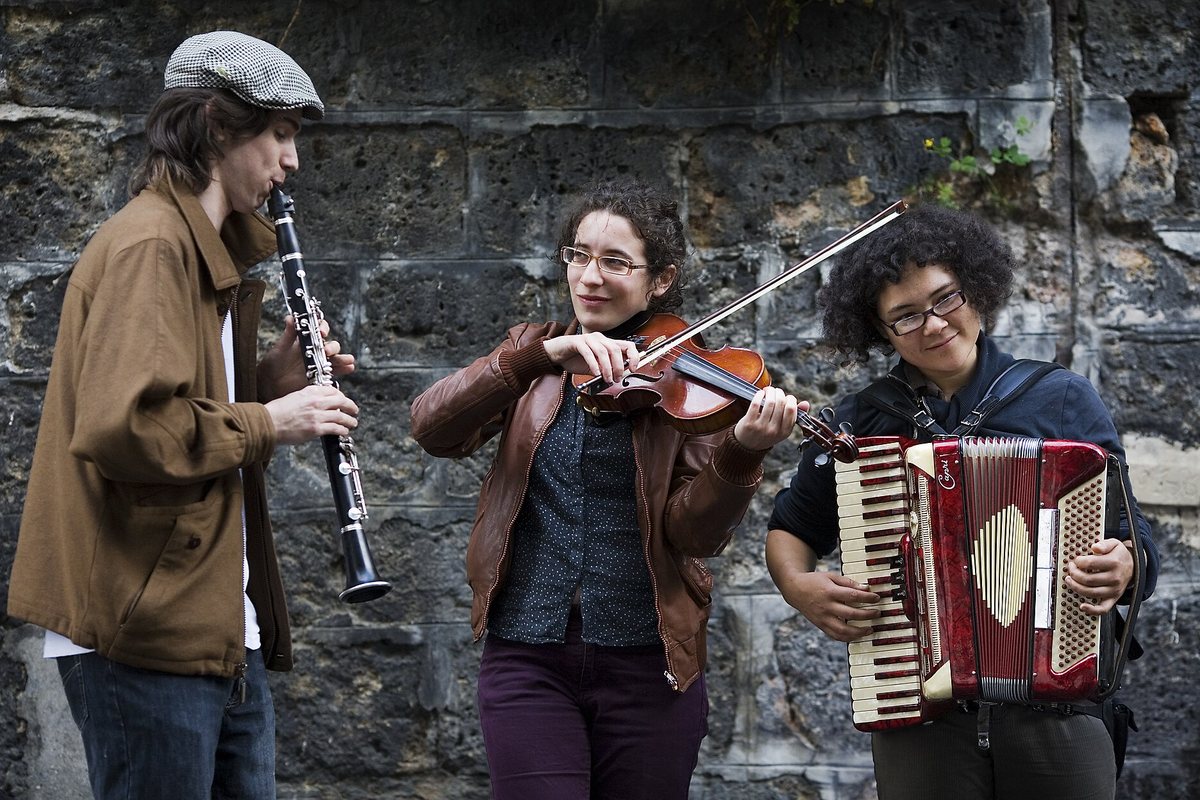 A clarinetist, violinist and accordionist performing outdoors in Montmartre, Paris