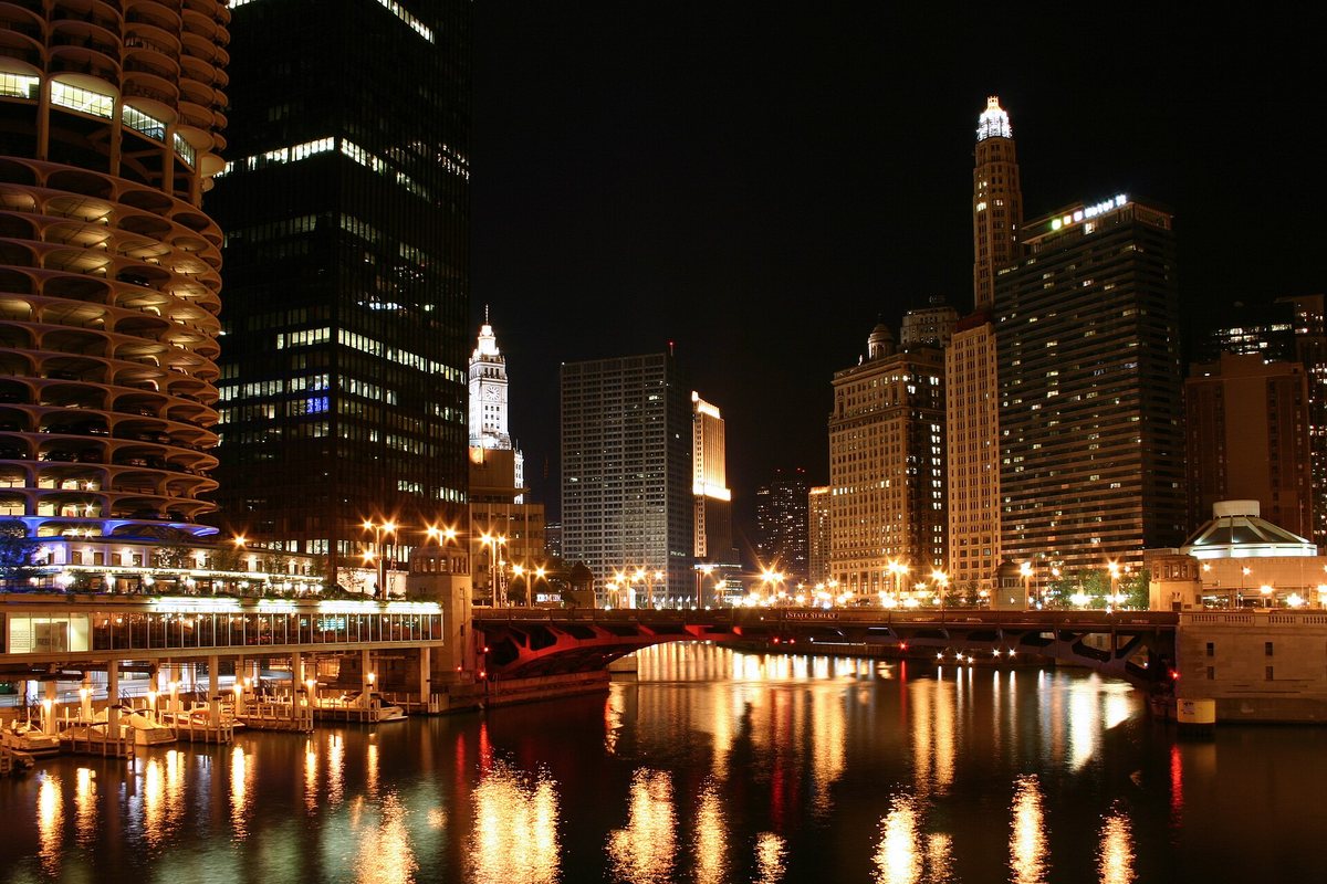 Nighttime buildings and bridge lights reflected in the Chicago River