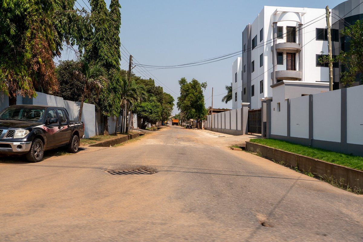 A residential street and modern buildings in Accra